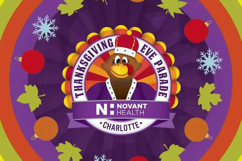 Thanksgiving Eve Parade mascot with festive decorations and sponsor logo.